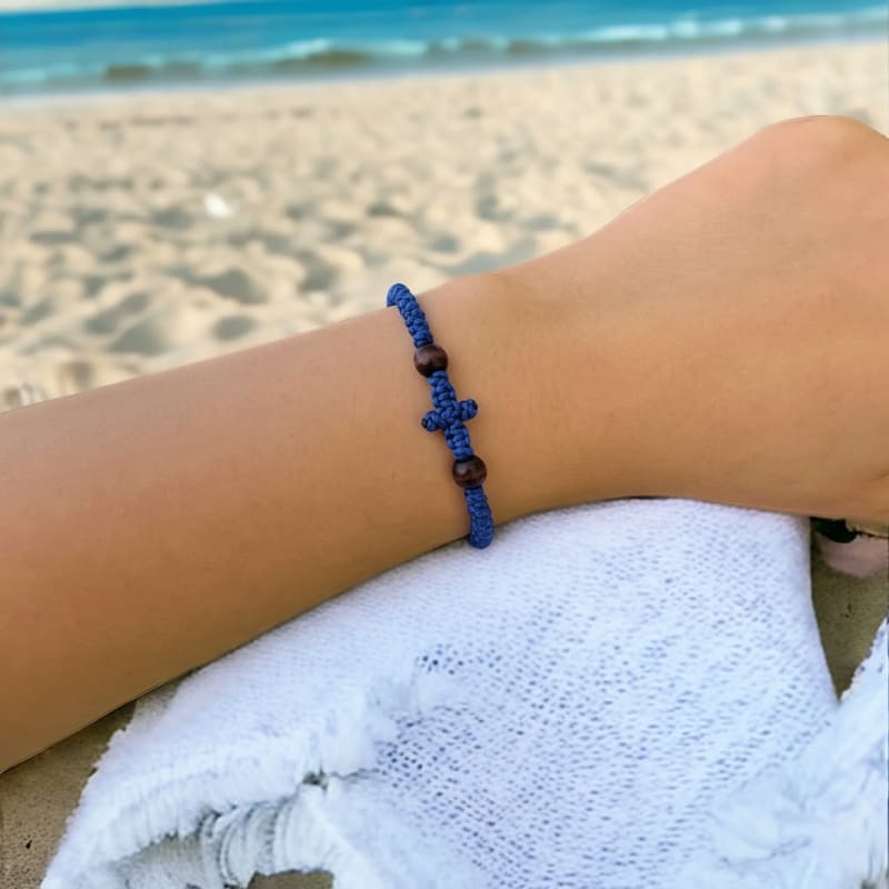 Bracelet komboskini bleu à 33 nœuds photographié sur la plage