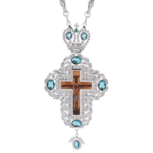 Collier pendentif croix pectorale argentée avec crucifix, pierres turquoise et chaîne longue.