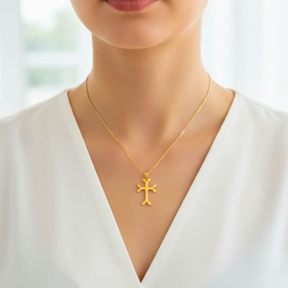Pendentif croix arménienne en or porté par une femme